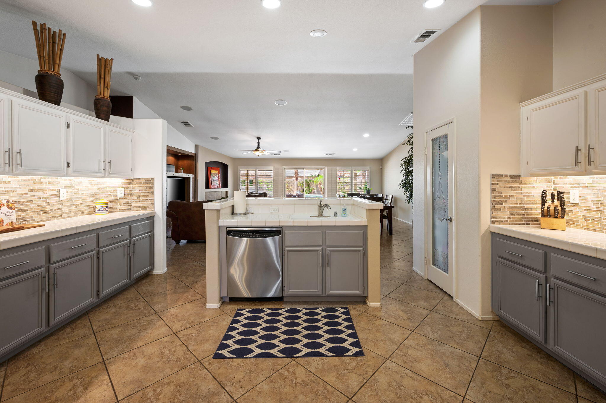 83414 Greenbrier Drive Indio, CA 92203 - Photo 15 of 43 a kitchen with a sink a counter top space and cabinets