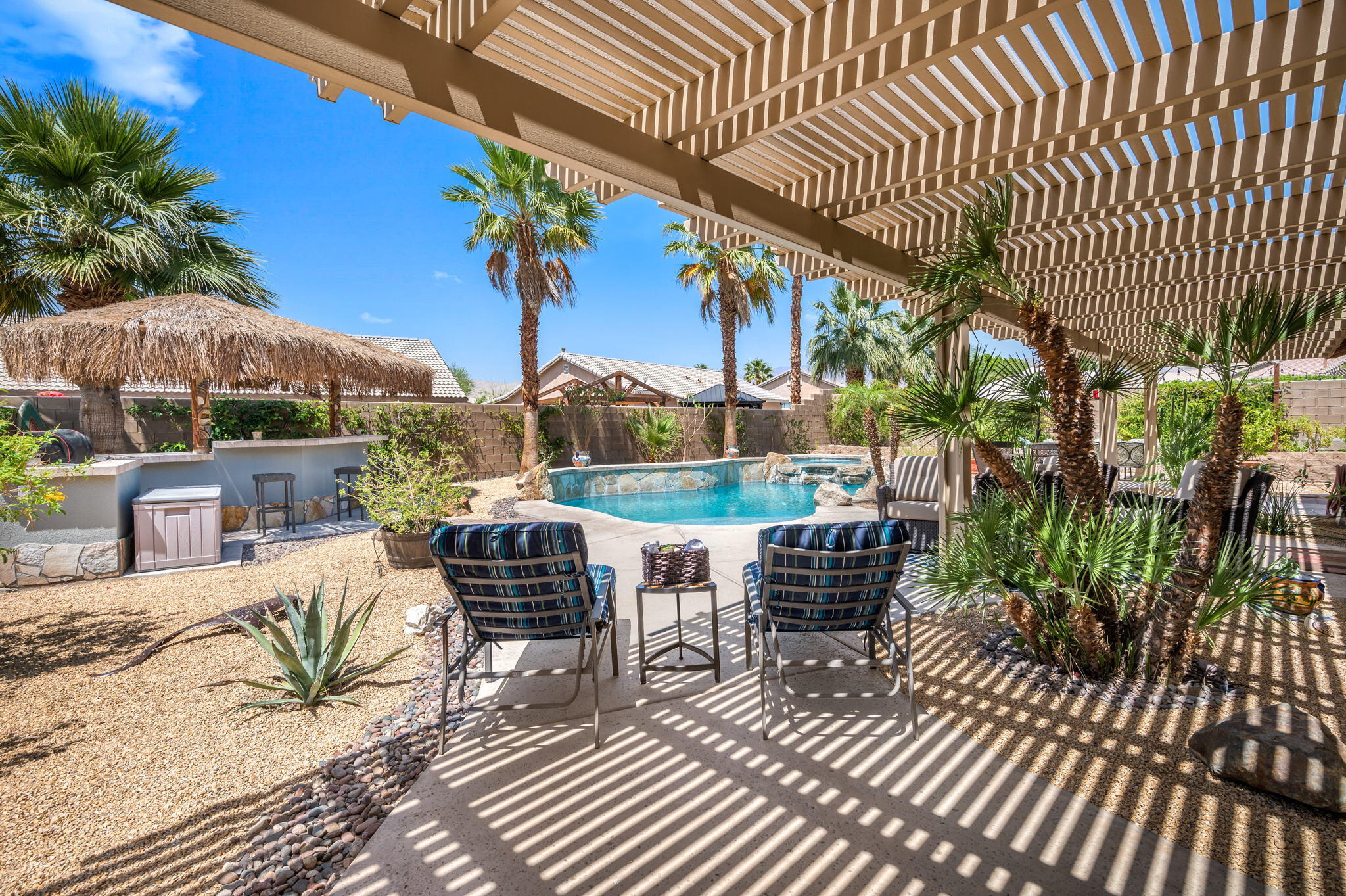 83414 Greenbrier Drive Indio, CA 92203 - Photo 30 of 43 a view of a patio with couches table and chairs and potted plants