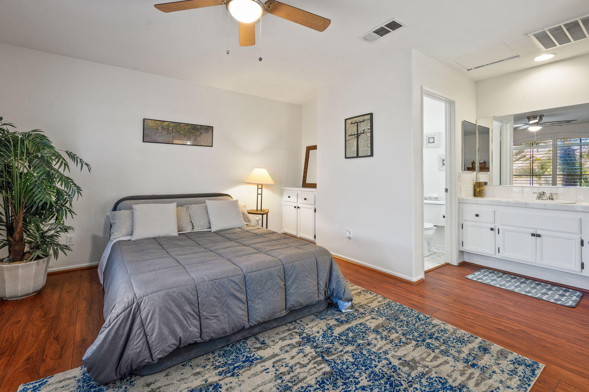 83414 Greenbrier Drive Indio, CA 92203 - Photo 3 of 43 a bedroom with a large bed and a potted plant