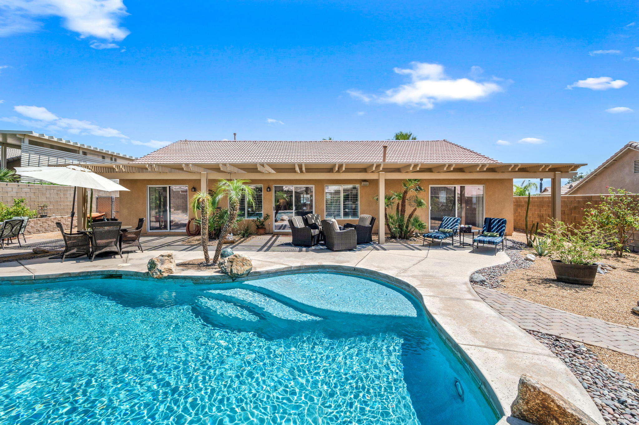 83414 Greenbrier Drive Indio, CA 92203 - Photo 32 of 43 a view of a house with swimming pool and porch