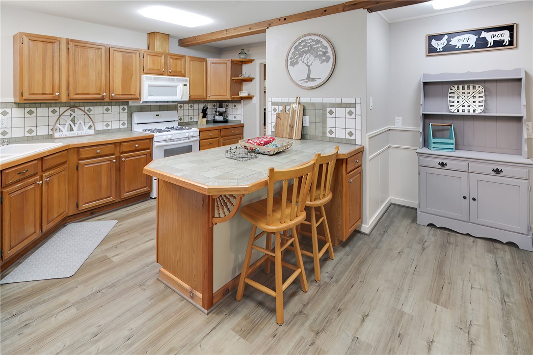8010 Perry Lane College Station, TX 77845 - Photo 16 of 47 a kitchen with a cabinets a sink and a stove with wooden floor