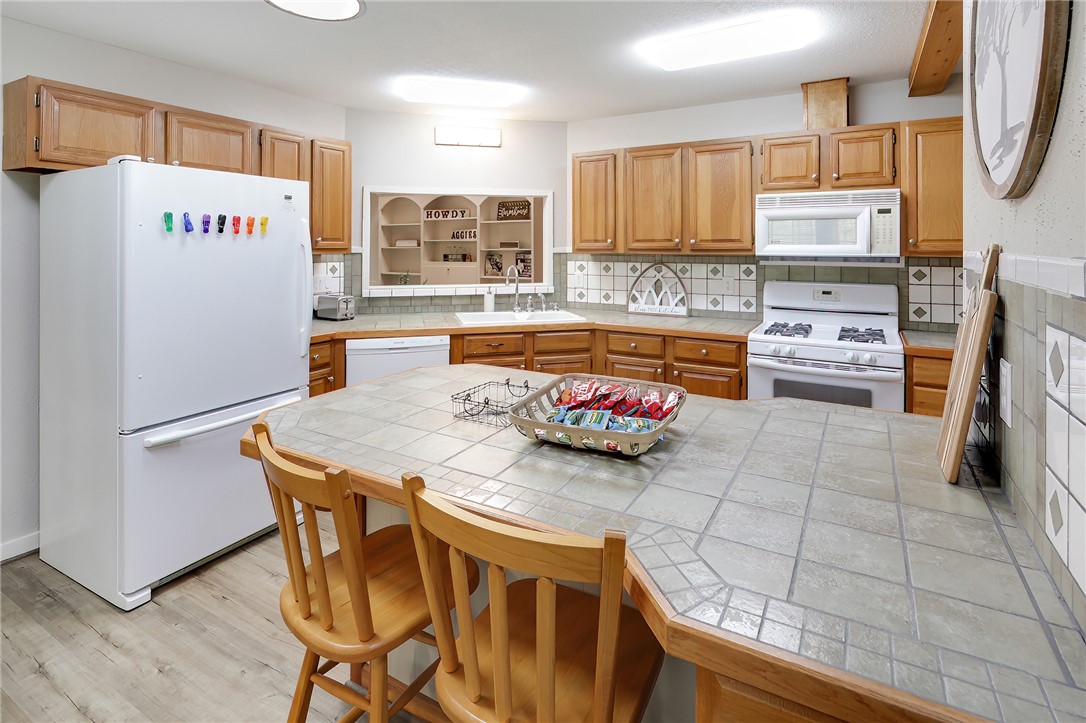 8010 Perry Lane College Station, TX 77845 - Photo 17 of 47 a kitchen with stainless steel appliances a stove a sink refrigerator and a oven