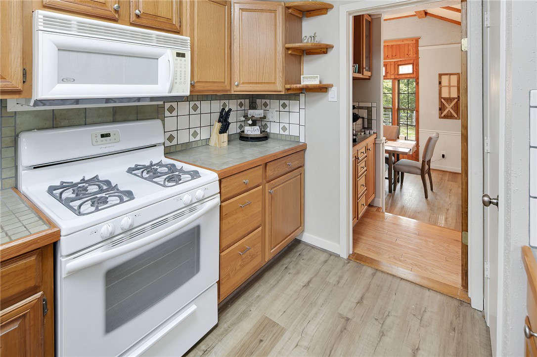 8010 Perry Lane College Station, TX 77845 - Photo 19 of 47 a kitchen with a stove a refrigerator and a cabinets