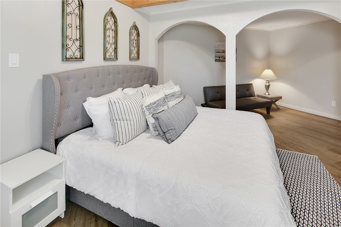 8010 Perry Lane College Station, TX 77845 - Photo 25 of 47 a bedroom with bed and wooden floor