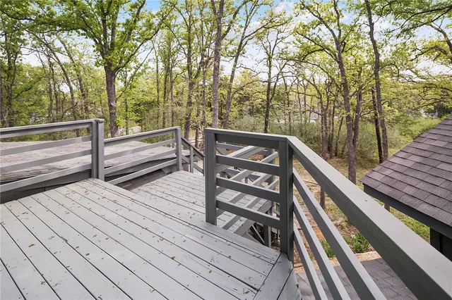 a view of a wooden deck and a backyard