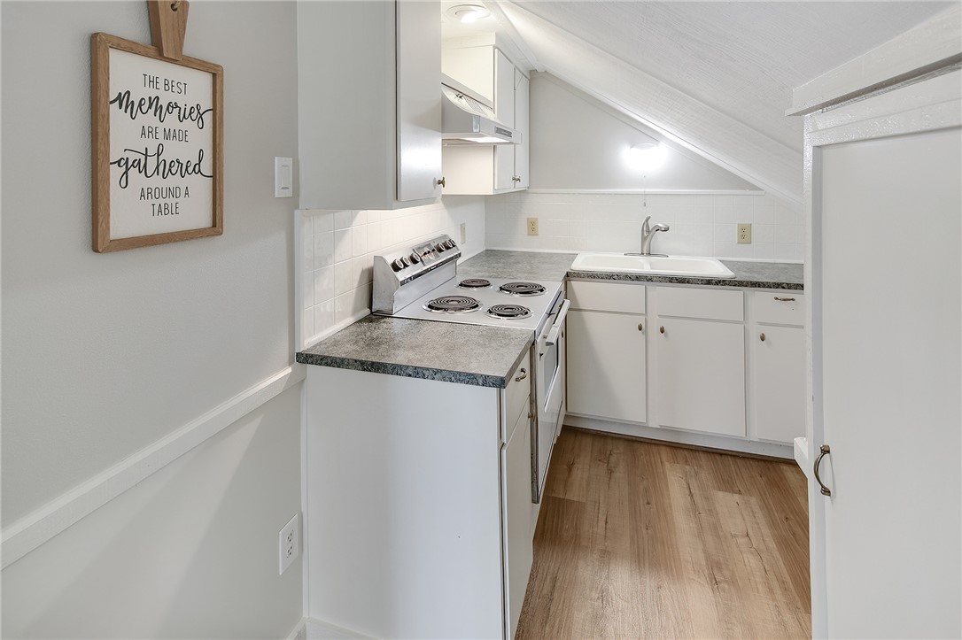 8010 Perry Lane College Station, TX 77845 - Photo 37 of 47 a kitchen with a stove top oven sink and cabinets