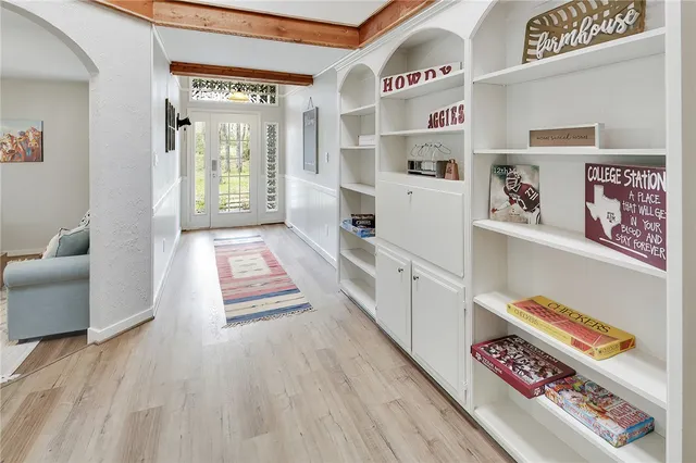 a view of a hallway with wooden floor and entryway
