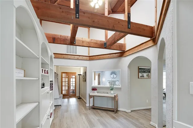 a living room with furniture and wooden floor
