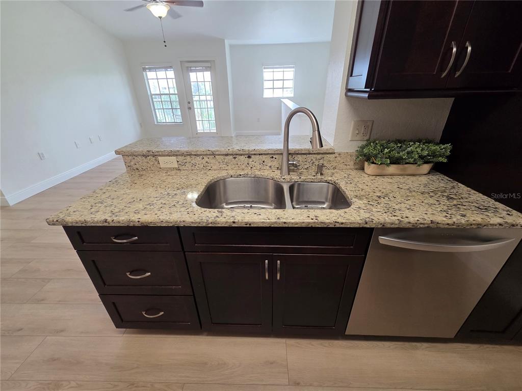 8905 Manor Loop, Unit 205 Lakewood Ranch, FL 34202 - Photo 12 of 30 a kitchen with a sink and cabinets
