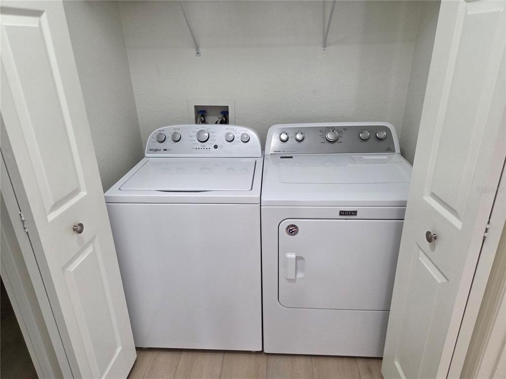 8905 Manor Loop, Unit 205 Lakewood Ranch, FL 34202 - Photo 15 of 30 a utility room with dryer and washer