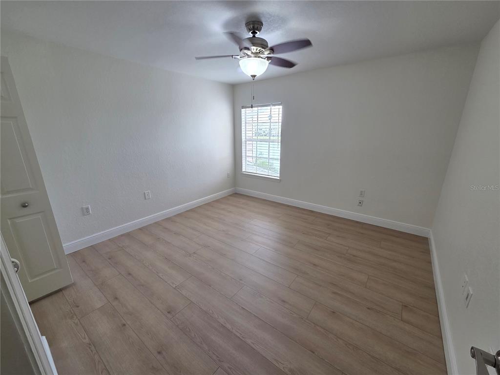 8905 Manor Loop, Unit 205 Lakewood Ranch, FL 34202 - Photo 17 of 30 wooden floor in an empty room with a window