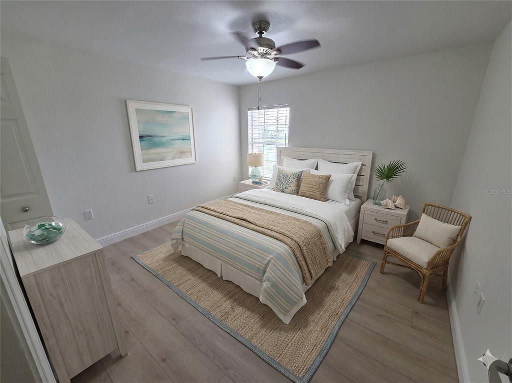 8905 Manor Loop, Unit 205 Lakewood Ranch, FL 34202 - Photo 18 of 30 a bedroom with a bed and a chandelier