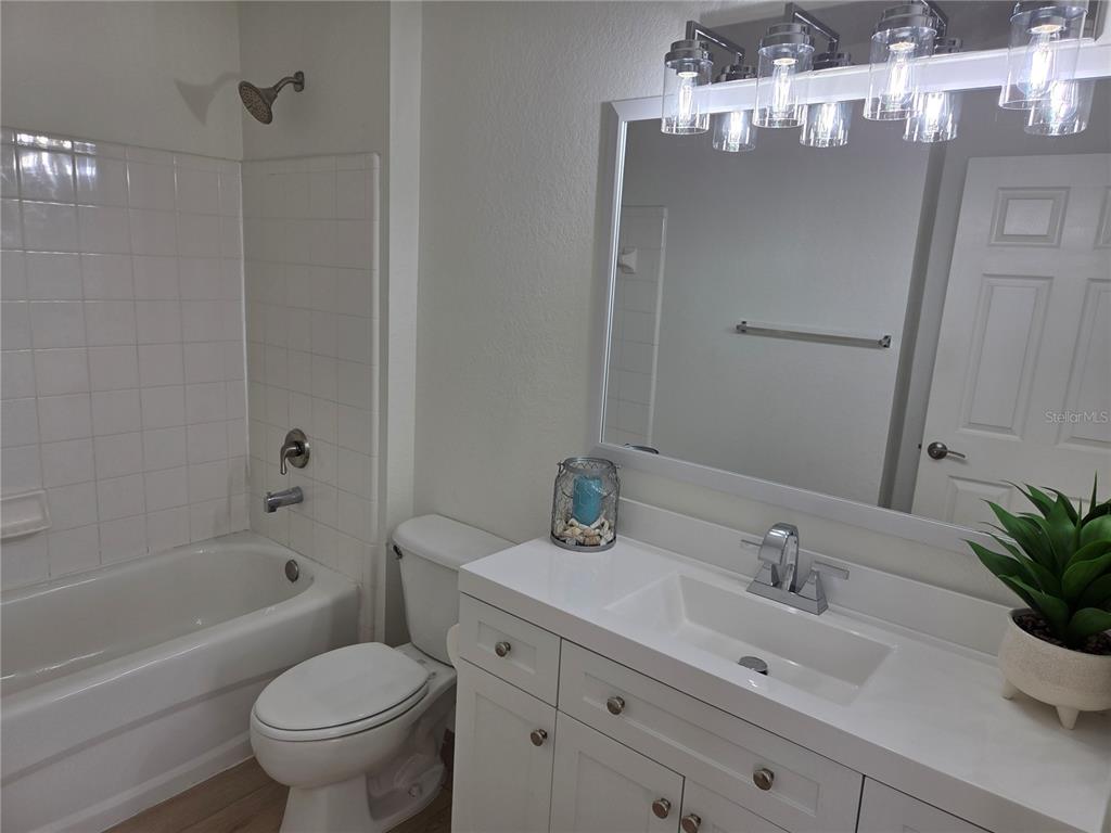 8905 Manor Loop, Unit 205 Lakewood Ranch, FL 34202 - Photo 24 of 30 a bathroom with a sink a toilet and shower