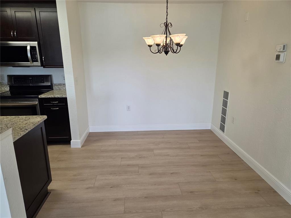8905 Manor Loop, Unit 205 Lakewood Ranch, FL 34202 - Photo 9 of 30 a view of a kitchen with a sink and dishwasher