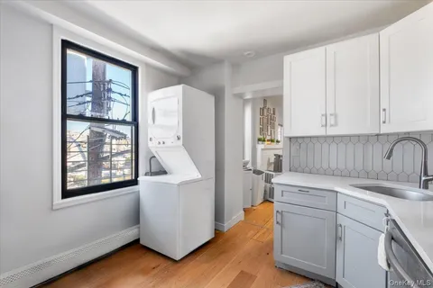 a utility room with cabinets dryer and washer