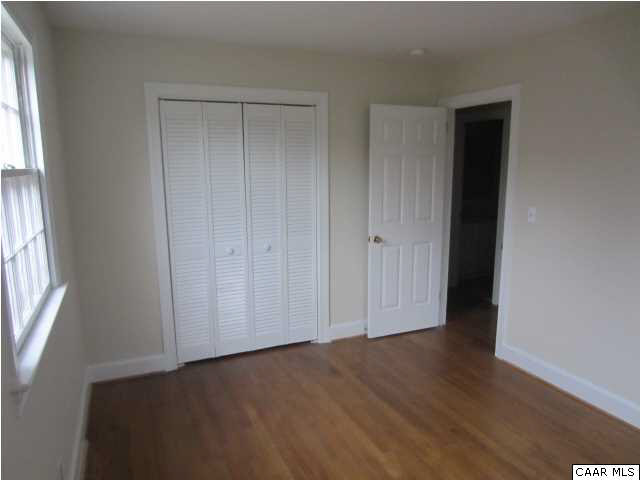 2606 Huntington Road Charlottesville, VA 22901 - Photo 8 of 19 an empty room with wooden floor and windows