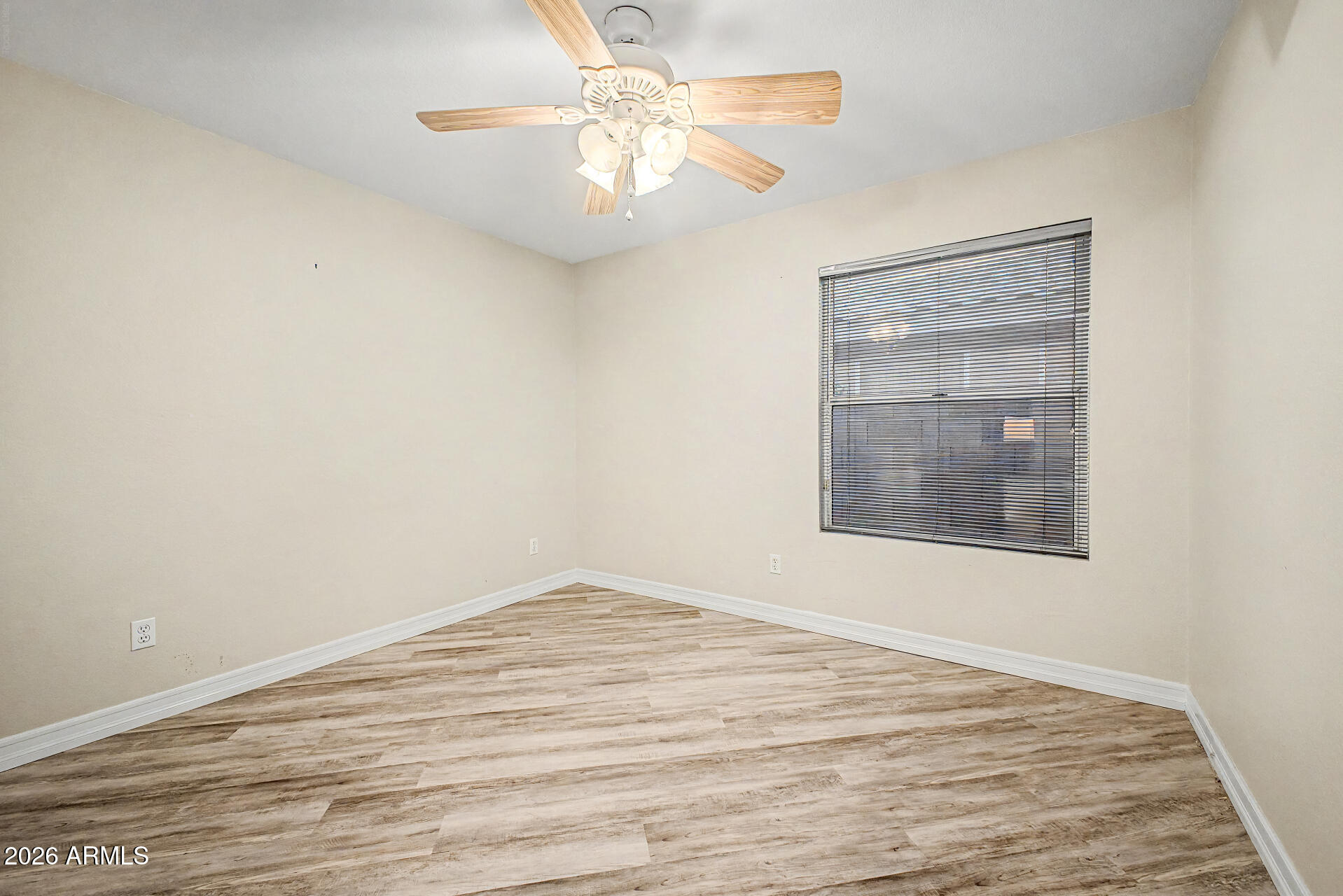 4102 East Rock Wren Road Phoenix, AZ 85044 - Photo 16 of 25 a view of an empty room with wooden floor and a chandelier fan