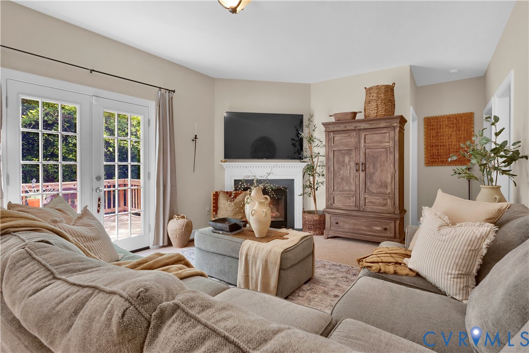 16148 Buckfast Place Beaverdam, VA 23015 - Photo 6 of 48 a living room with furniture a fireplace and a flat screen tv