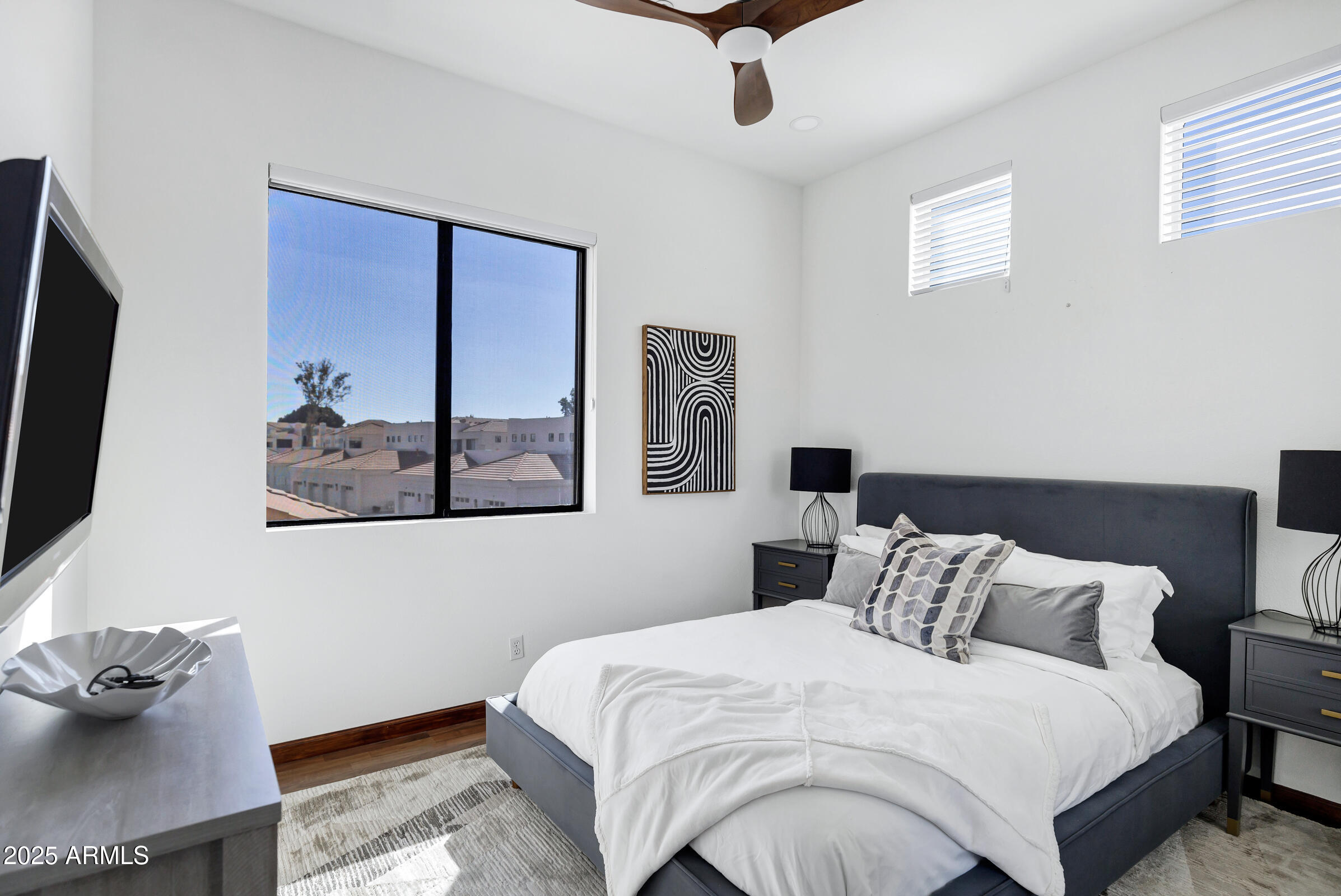 8270 North Hayden Road, Unit 2010 Scottsdale, AZ 85258 - Photo 23 of 54 a bedroom with bed and painting on the wall