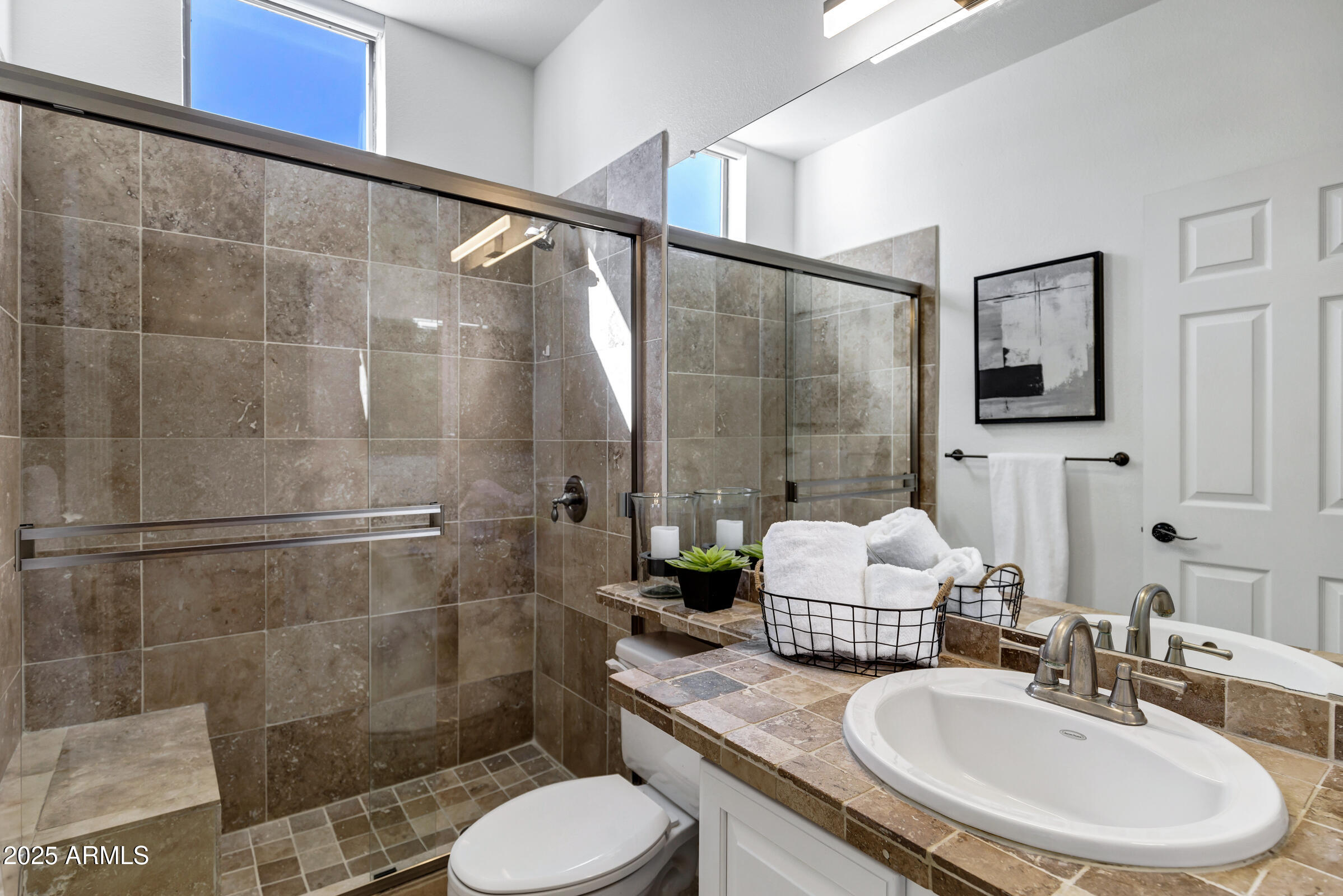 8270 North Hayden Road, Unit 2010 Scottsdale, AZ 85258 - Photo 24 of 54 a bathroom with a sink toilet a mirror and shower