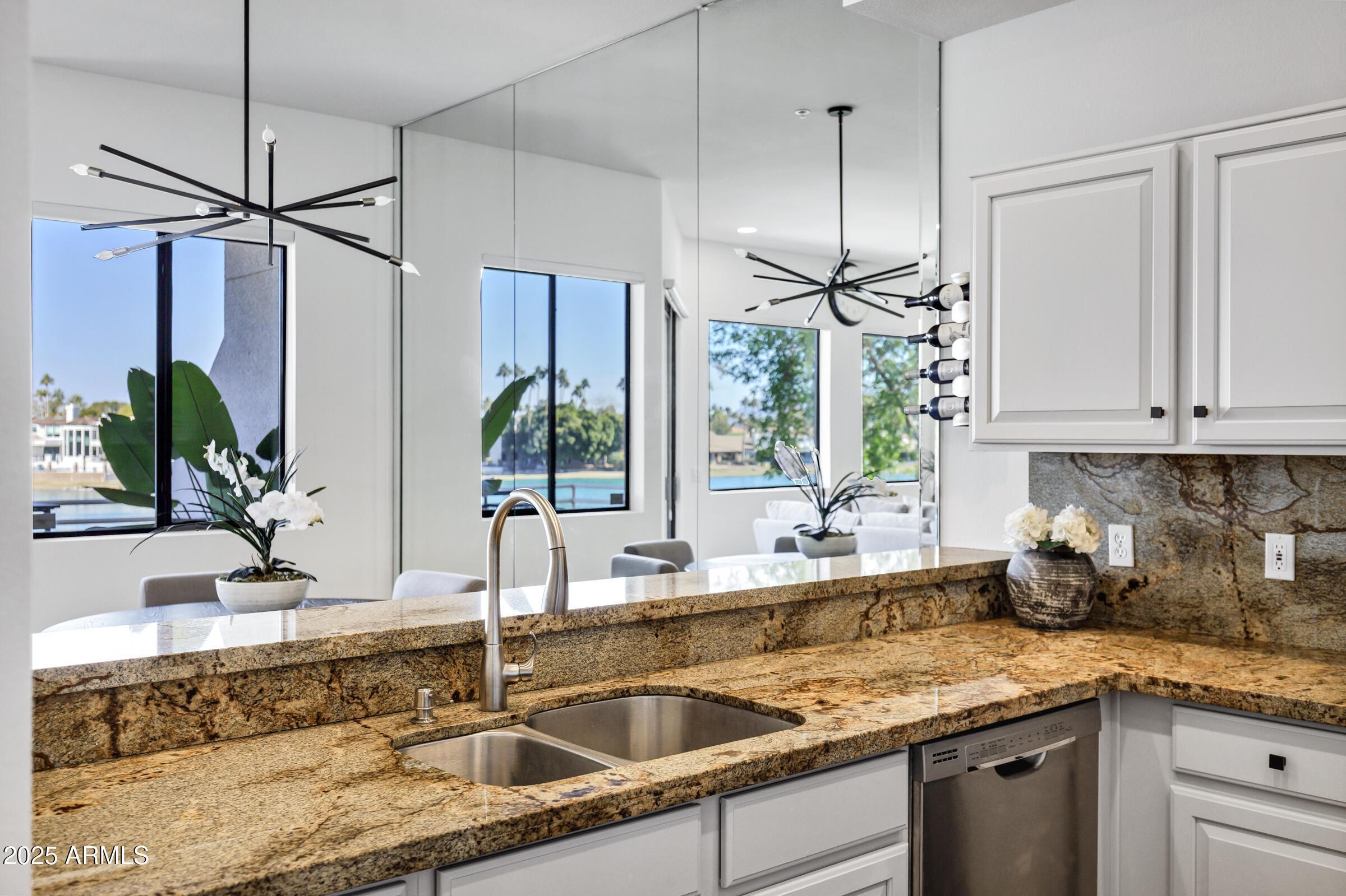 8270 North Hayden Road, Unit 2010 Scottsdale, AZ 85258 - Photo 39 of 54 a kitchen with stainless steel appliances granite countertop a sink a counter space and a granite counter tops