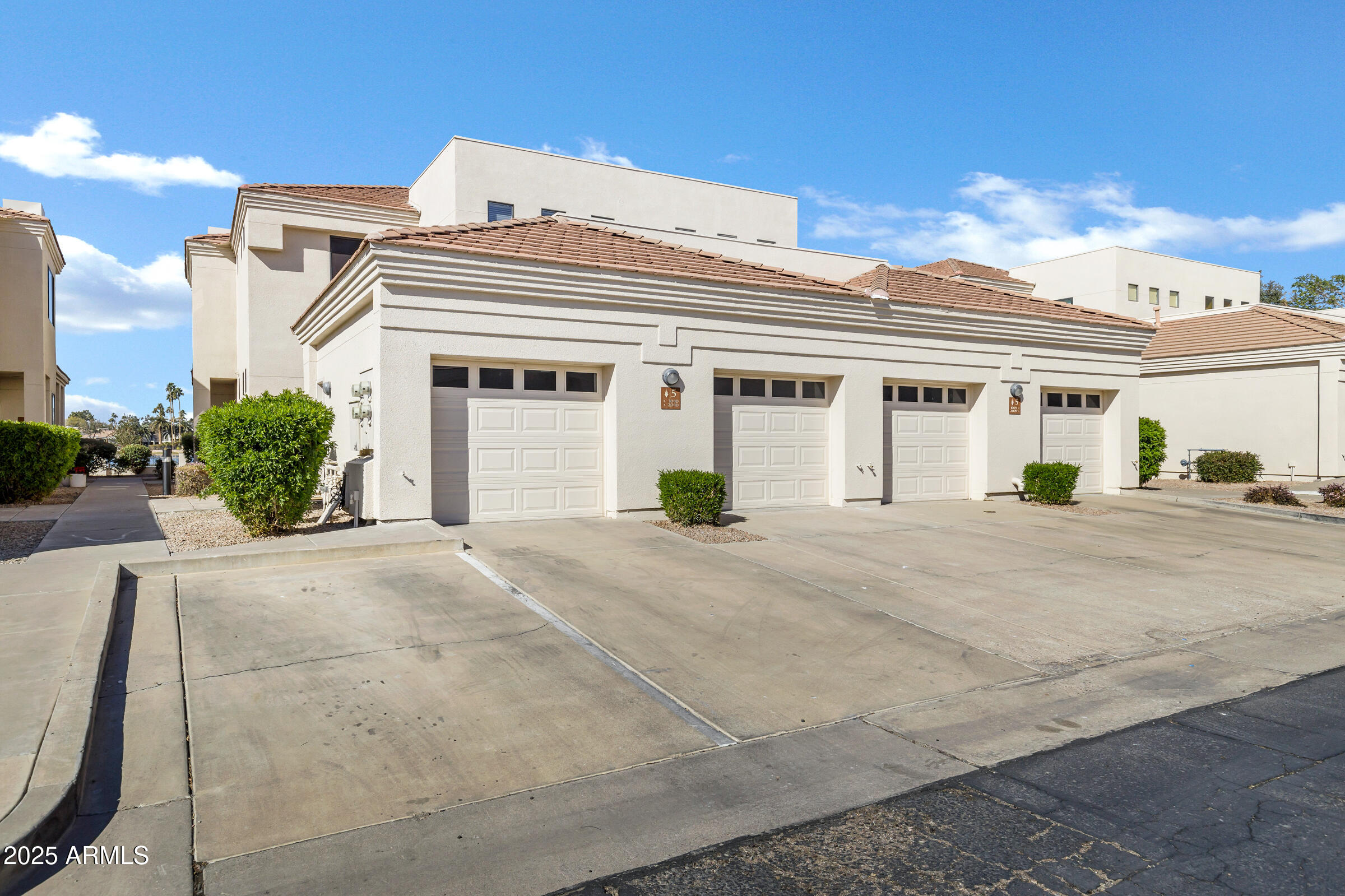 8270 North Hayden Road, Unit 2010 Scottsdale, AZ 85258 - Photo 49 of 54 a view of a white building among the street with palm trees