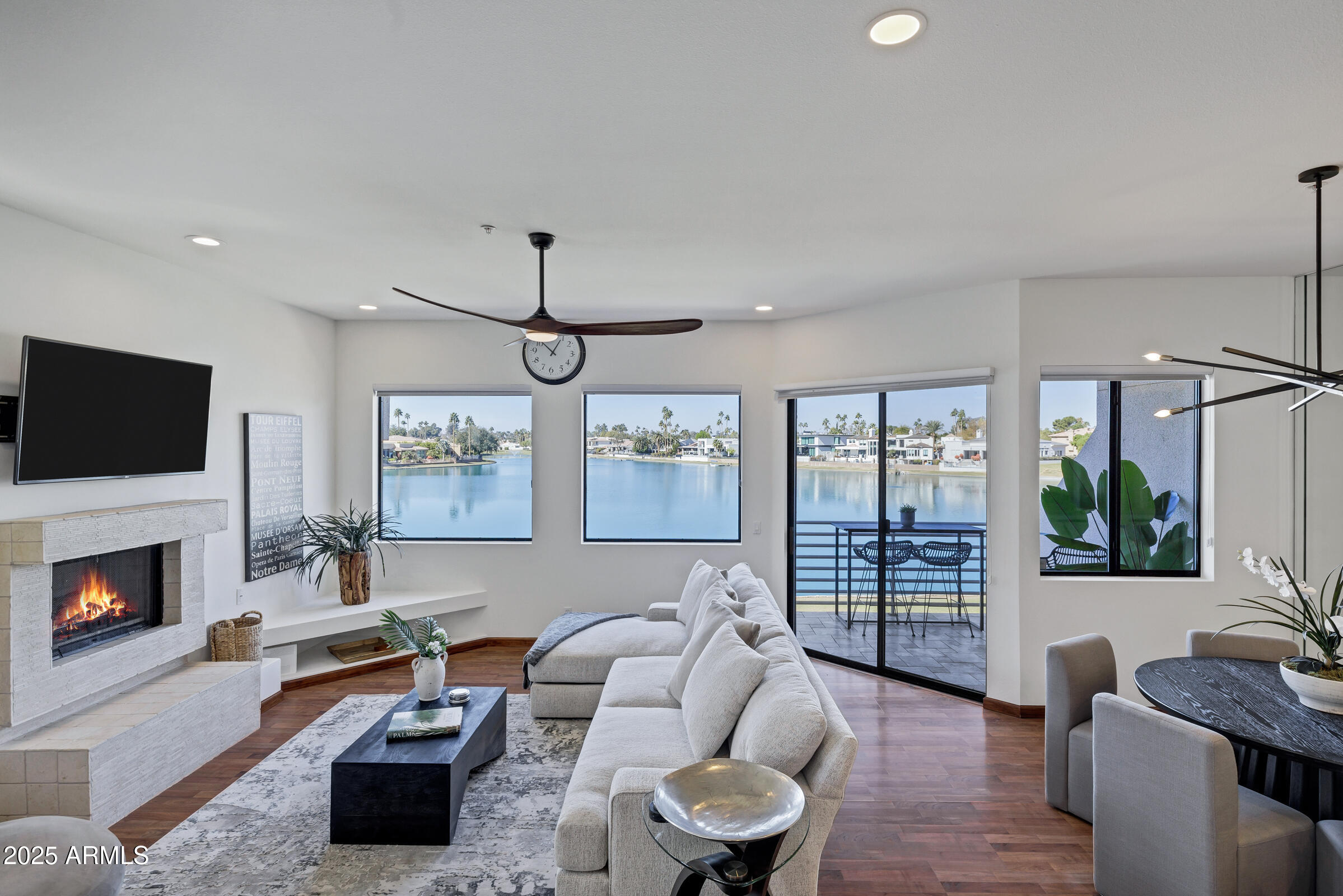 8270 North Hayden Road, Unit 2010 Scottsdale, AZ 85258 - Photo 5 of 54 a living room with furniture a flat screen tv and a fireplace