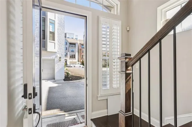 a view of a hallway with wooden floor and staircase
