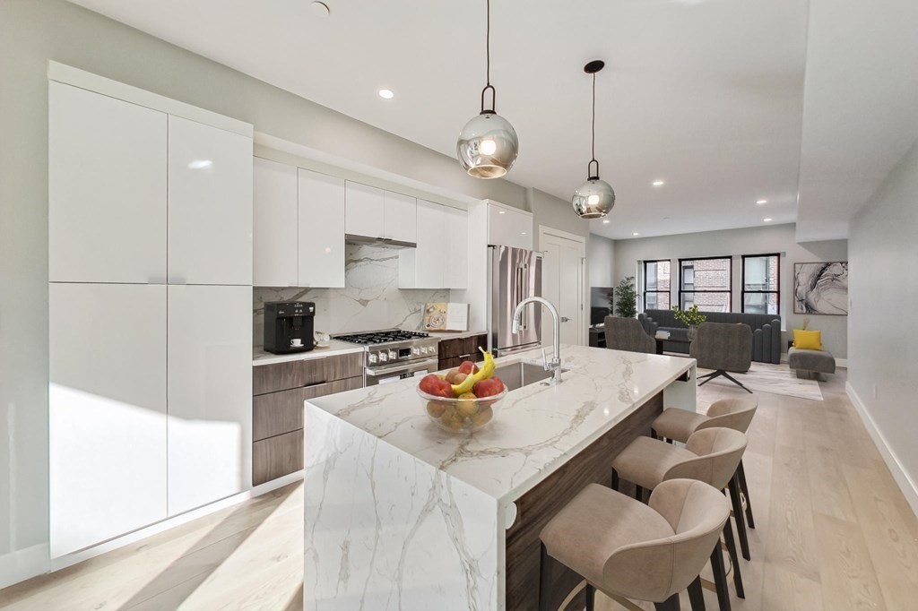 a kitchen with a dining table chairs stainless steel appliances and cabinets