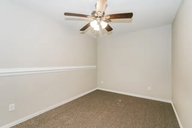 a view of an empty room with a fan