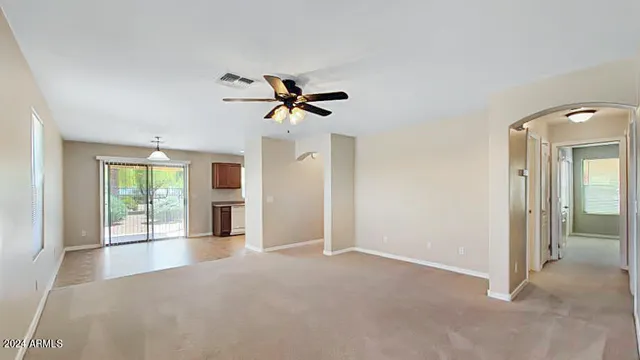 a view of a livingroom with a ceiling fan and window