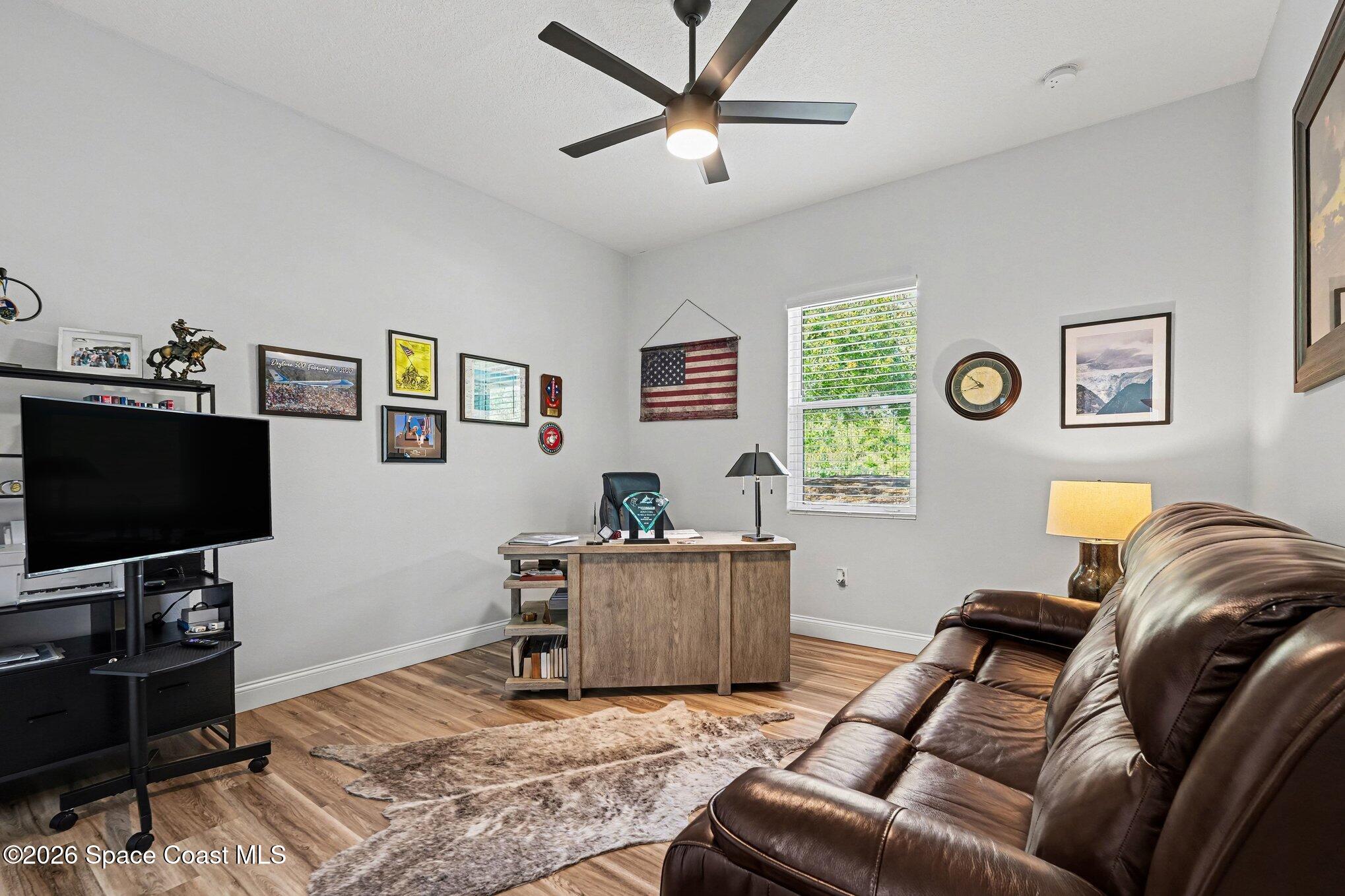 3270 Quantum Place Mims, FL 32754 - Photo 18 of 28 a living room with furniture and a flat screen tv
