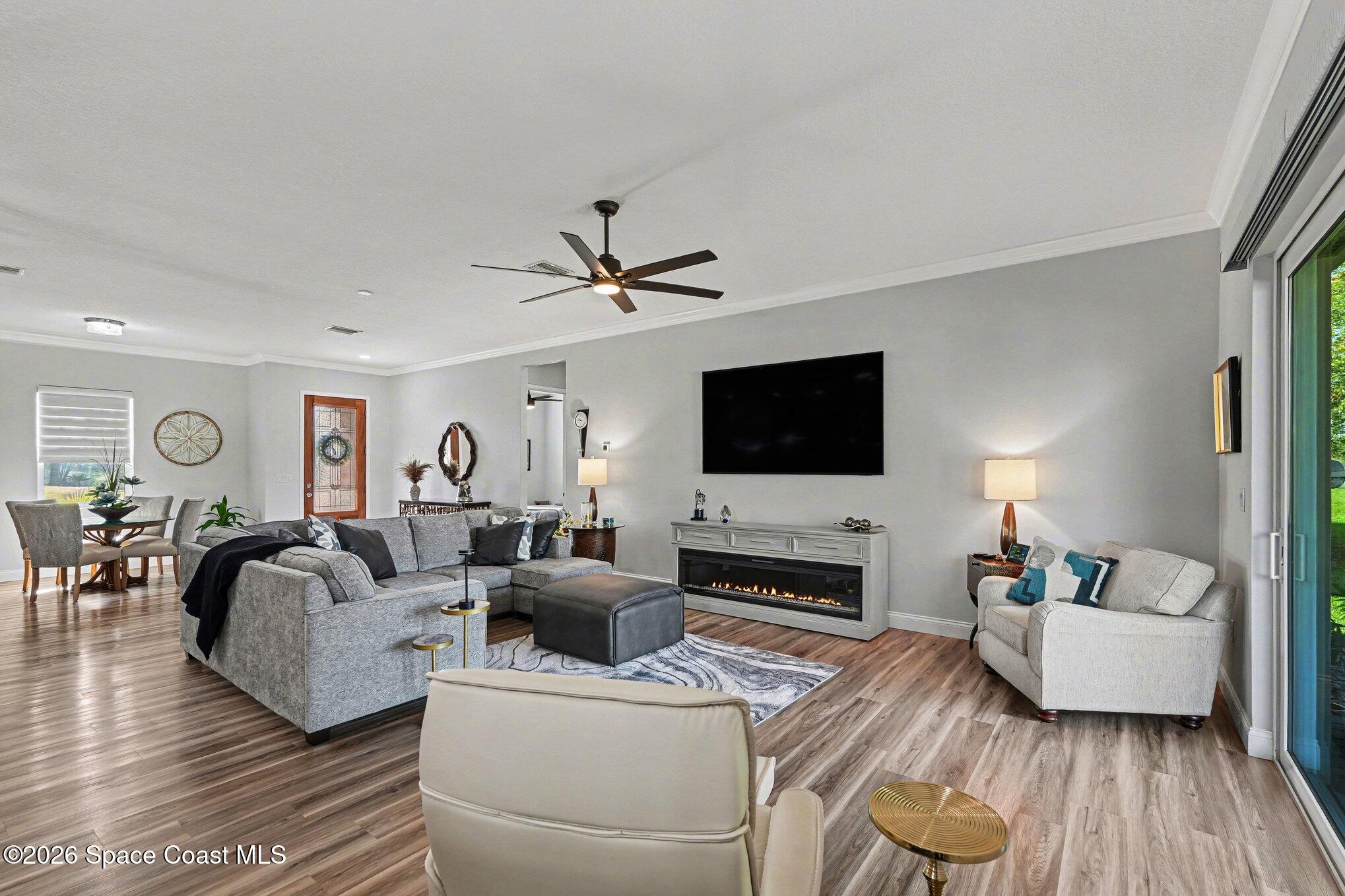 3270 Quantum Place Mims, FL 32754 - Photo 6 of 28 a living room with furniture flat screen tv and wooden floor