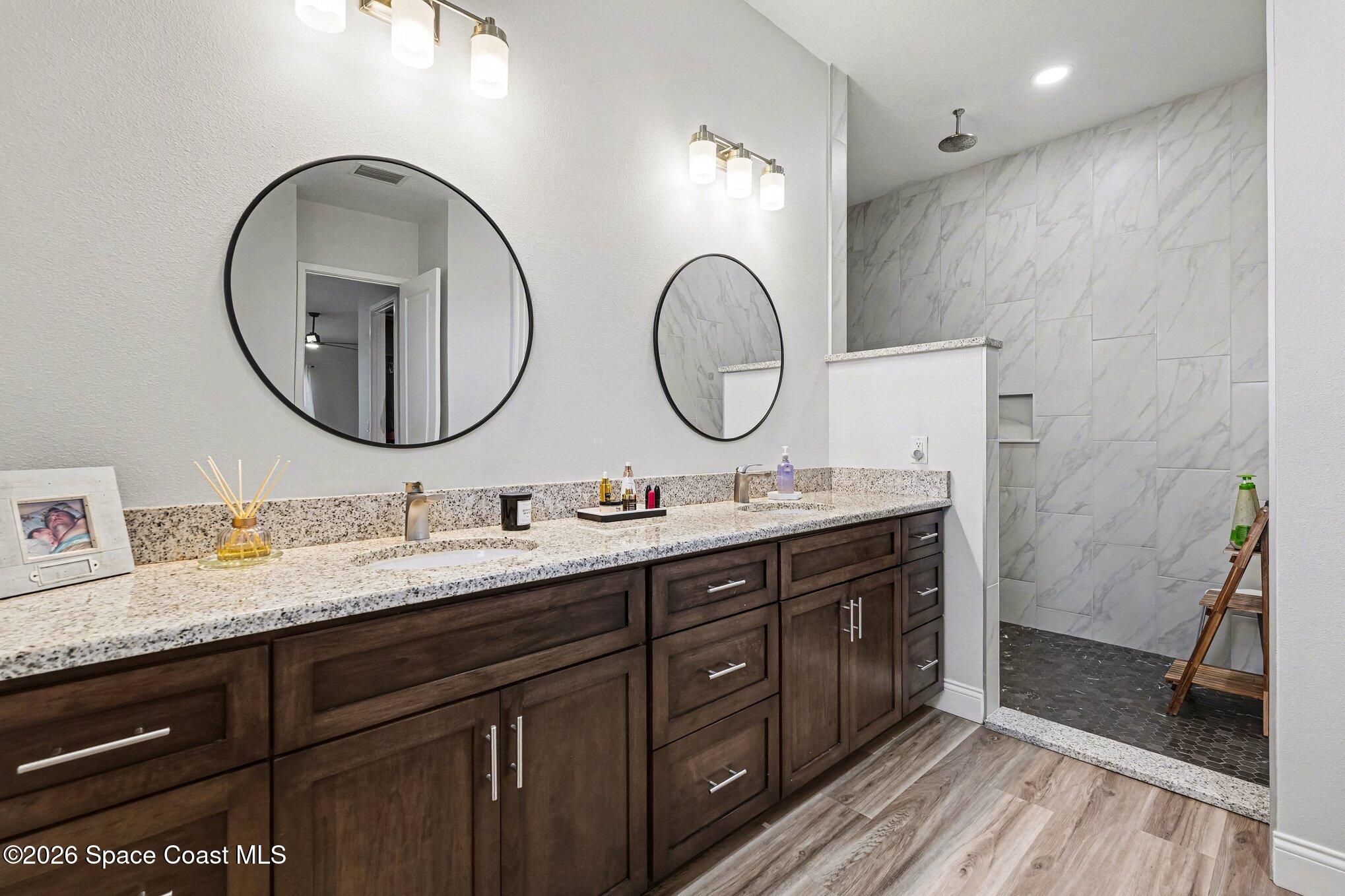 3270 Quantum Place Mims, FL 32754 - Photo 8 of 28 a bathroom with a double vanity sink and a mirror