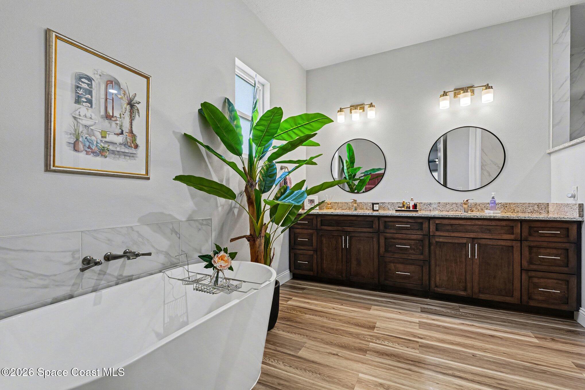 3270 Quantum Place Mims, FL 32754 - Photo 9 of 28 a spacious bathroom with a granite countertop double vanity sink and a mirror