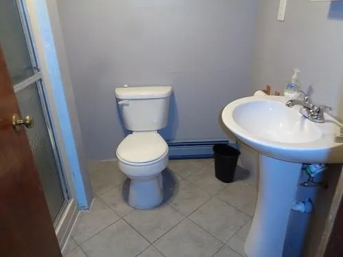 a bathroom with a sink toilet and a mirror
