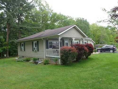 a front view of house with yard and green space