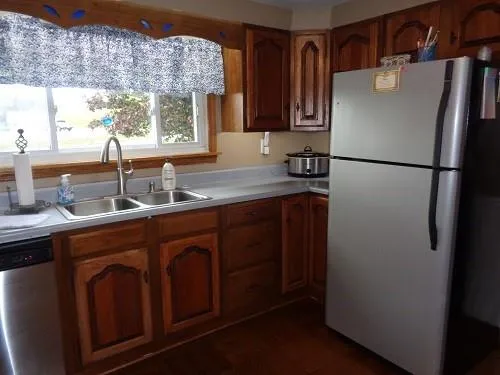 a kitchen with stainless steel appliances granite countertop a refrigerator and a sink