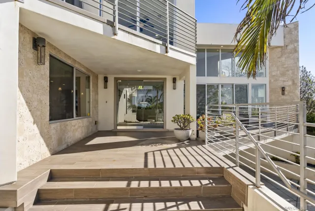 a living room with furniture a flat screen tv and a large window