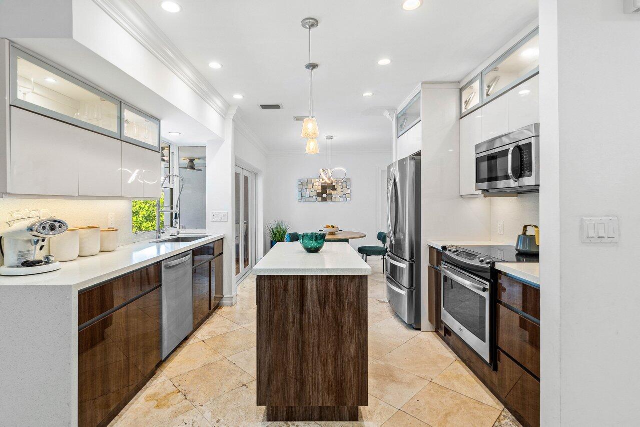 1181 Walnut Terrace Boca Raton, FL 33486 - Photo 14 of 26 a large kitchen with stainless steel appliances kitchen island granite countertop a refrigerator and a sink