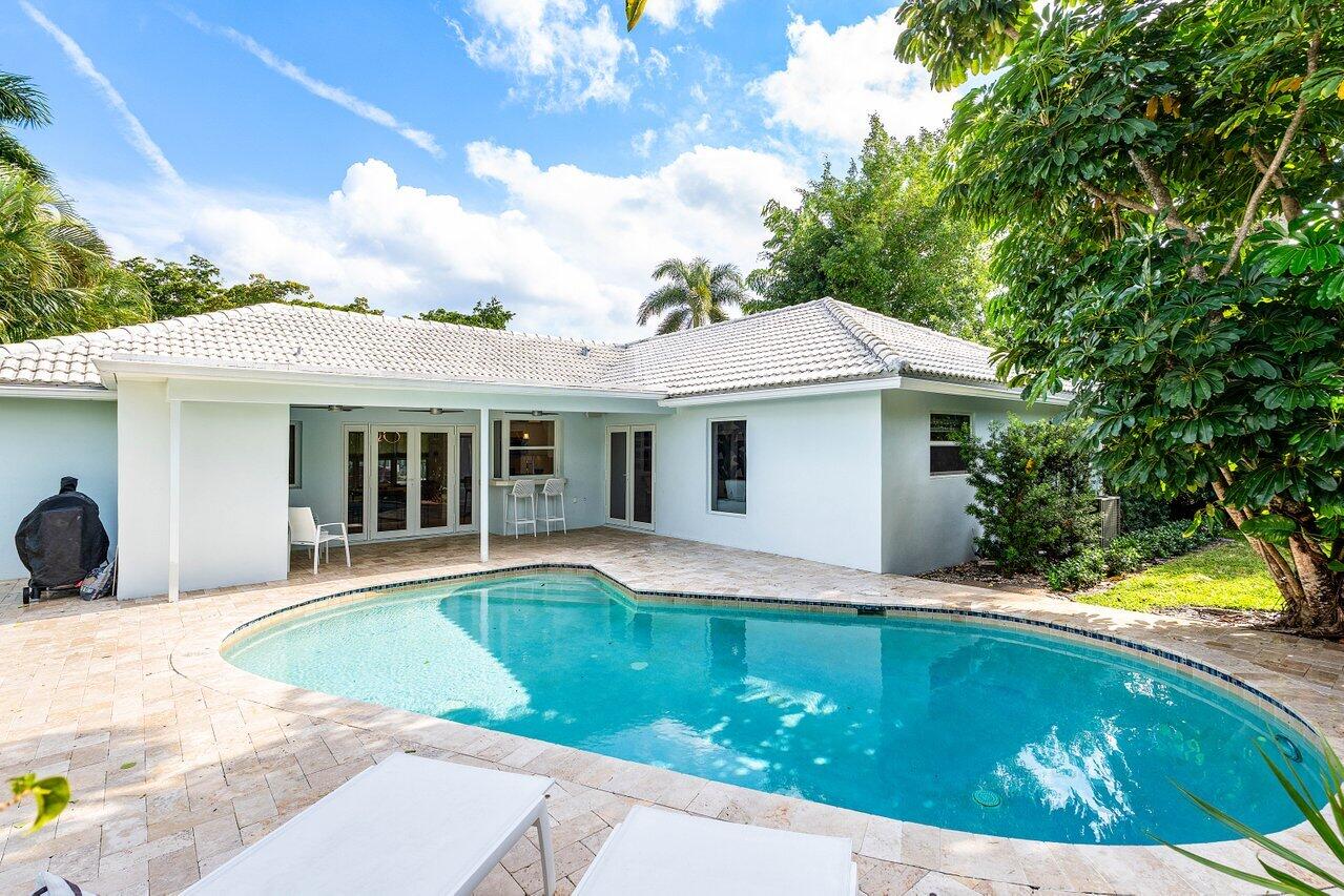 1181 Walnut Terrace Boca Raton, FL 33486 - Photo 25 of 26 a view of a house with a swimming pool and porch