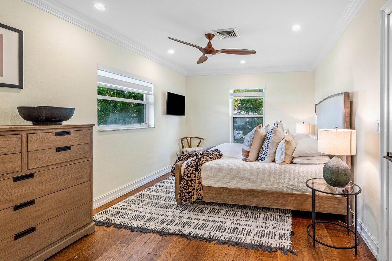 1181 Walnut Terrace Boca Raton, FL 33486 - Photo 6 of 26 a bedroom with a bed and wooden floor