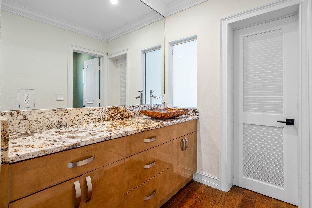 1181 Walnut Terrace Boca Raton, FL 33486 - Photo 8 of 26 a bathroom with a granite countertop sink and a mirror