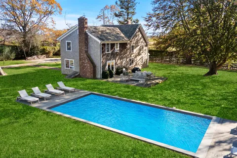 a view of a house with wooden fence