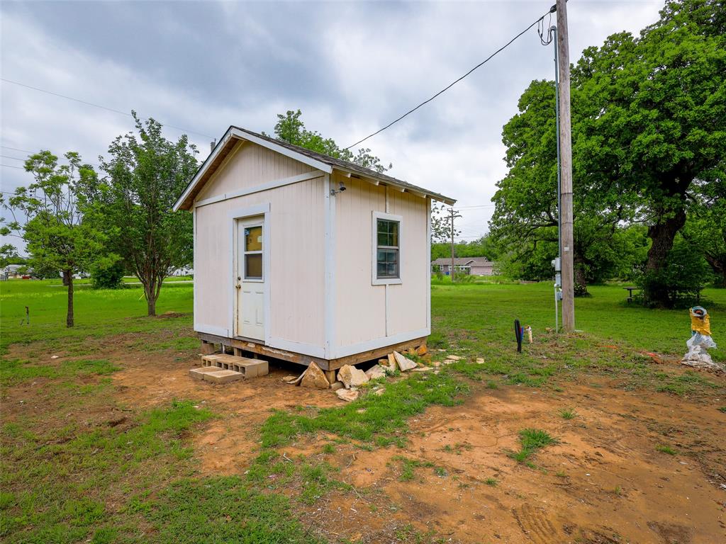 609 West 12th Street Cisco, TX 76437 - Photo 4 of 11 a view of a small house with a yard