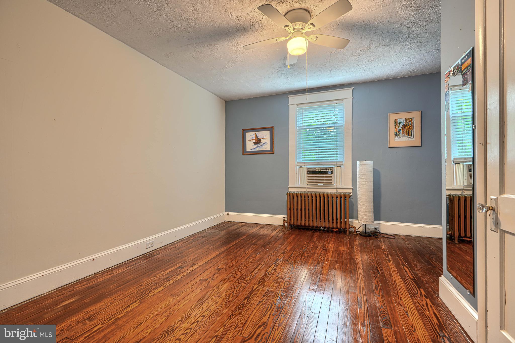 2705 Latona Road Baltimore, MD 21214 - Photo 41 of 53 a room with wooden floor and a window