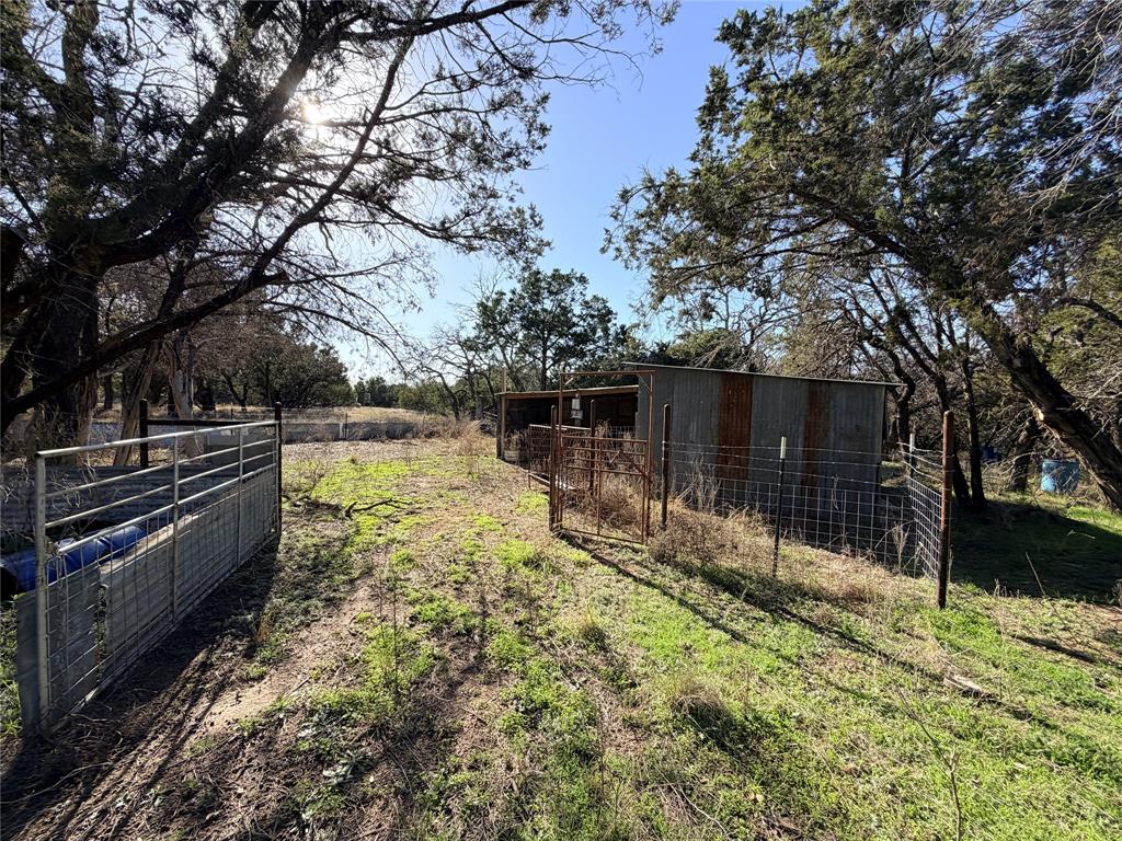 360 State Highway South Goldthwaite, TX 76844 - Photo 3 of 40 a view of backyard with wooden fence and a large tree