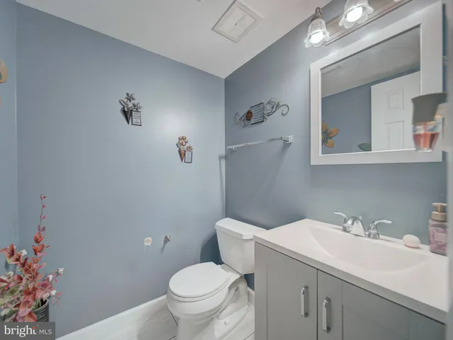 a bathroom with a sink mirror and toilet
