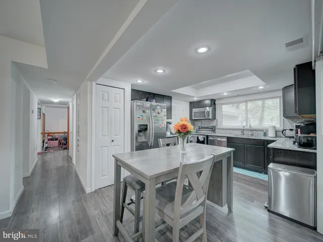 a kitchen with stainless steel appliances a sink and cabinets