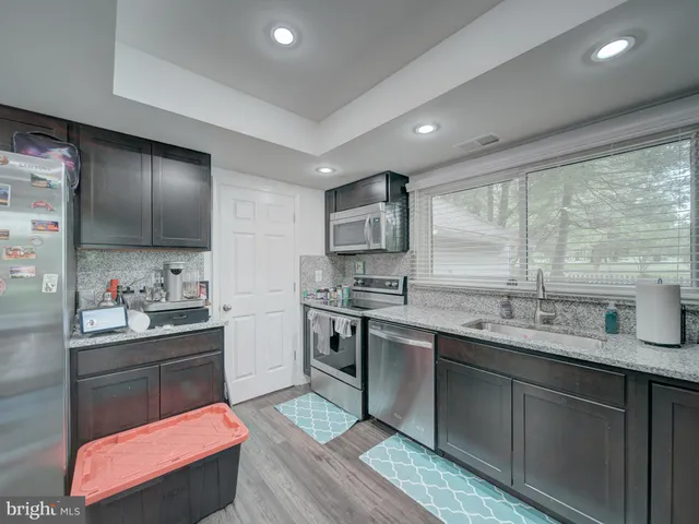 a kitchen with sink cabinets and window